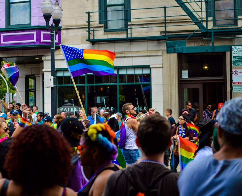 Vibrant Pride parade on a Chicago street with diverse attendees and rainbow flags waving.